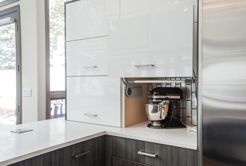 Exempel på ett mycket stort modernt vit vitt kök, med en undermonterad diskho, släta luckor, grå skåp, bänkskiva i kvarts, grått stänkskydd, stänkskydd i glaskakel, rostfria vitvaror, ljust trägolv, en halv köksö och brunt golv