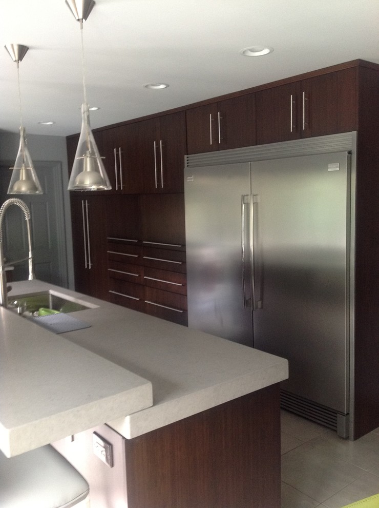 Example of a mid-sized trendy l-shaped porcelain tile eat-in kitchen design in Boston with a single-bowl sink, flat-panel cabinets, dark wood cabinets, quartz countertops, stainless steel appliances, multicolored backsplash, ceramic backsplash and an island