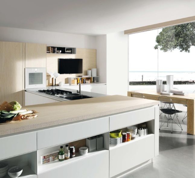 Photo of a large contemporary l-shaped kitchen/diner in San Francisco with a built-in sink, flat-panel cabinets, light wood cabinets, wood worktops, stainless steel appliances, marble flooring and grey floors.