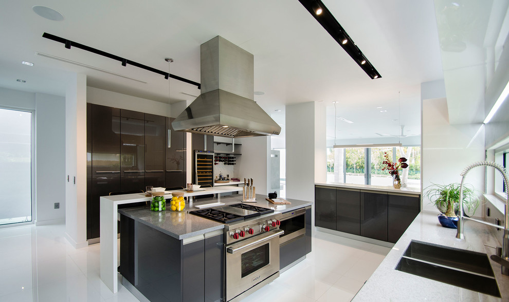 Design ideas for a large modern l-shaped enclosed kitchen in Miami with a double-bowl sink, flat-panel cabinets, white cabinets, engineered stone countertops, window splashback, stainless steel appliances, porcelain flooring, an island and white floors.