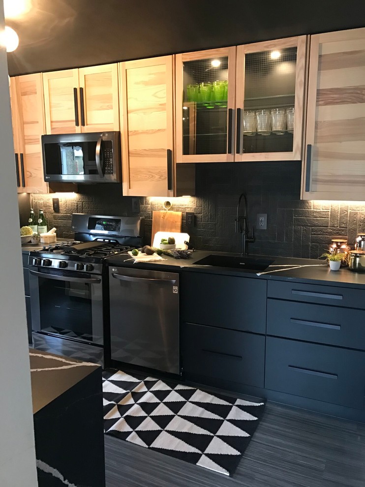 Inspiration for a mid-sized contemporary single-wall porcelain tile and gray floor enclosed kitchen remodel in New York with an undermount sink, shaker cabinets, light wood cabinets, soapstone countertops, black backsplash, brick backsplash, stainless steel appliances and no island