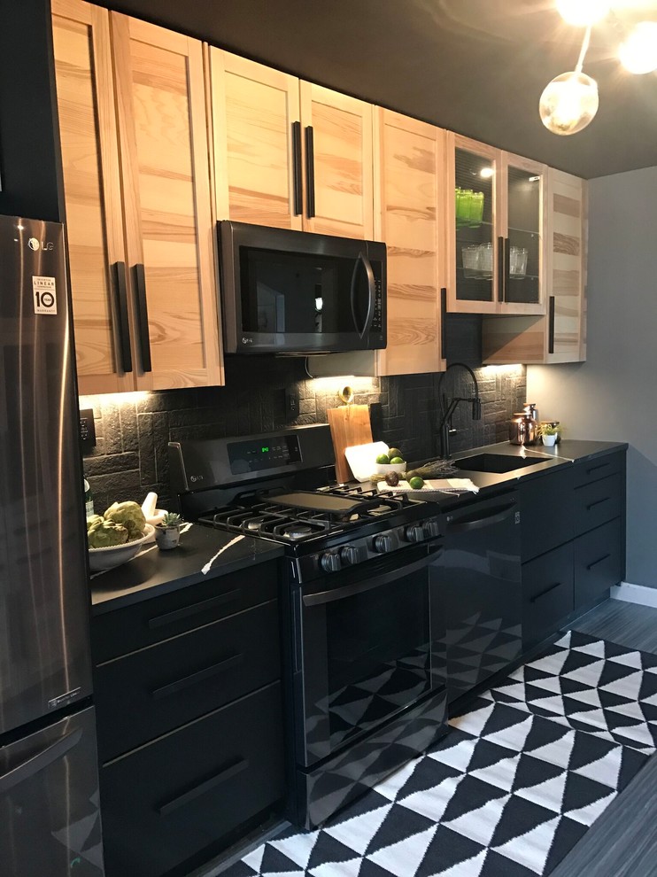 Enclosed kitchen - mid-sized contemporary single-wall porcelain tile and gray floor enclosed kitchen idea in New York with an undermount sink, shaker cabinets, light wood cabinets, soapstone countertops, black backsplash, brick backsplash, stainless steel appliances and no island