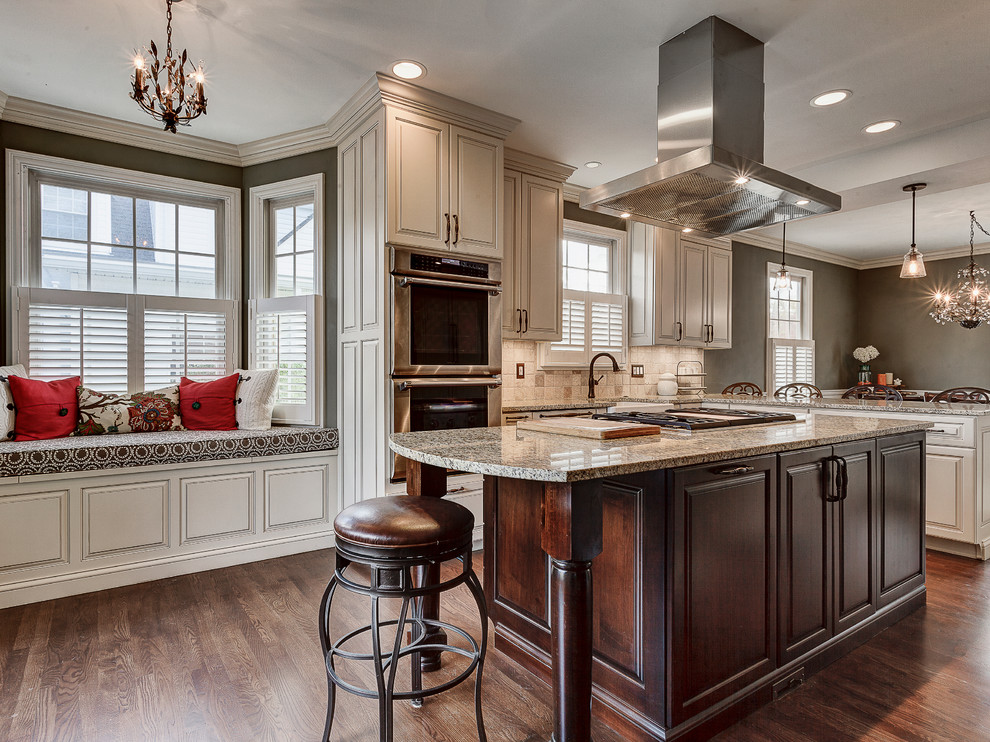 Example of a mountain style enclosed kitchen design in Columbus with a farmhouse sink, flat-panel cabinets, white cabinets, marble countertops, beige backsplash, stone tile backsplash and stainless steel appliances