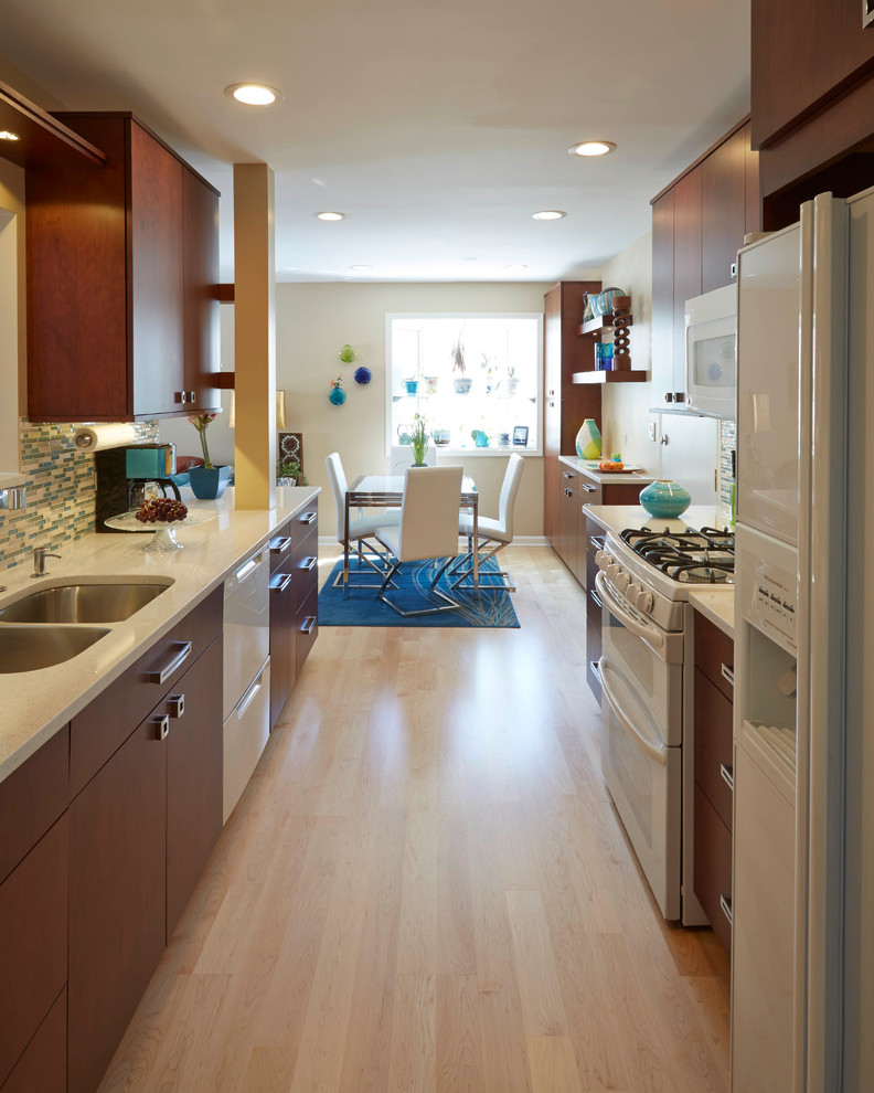 Eat-in kitchen - small contemporary galley light wood floor eat-in kitchen idea in Chicago with an undermount sink, flat-panel cabinets, dark wood cabinets, quartz countertops, blue backsplash, mosaic tile backsplash, white appliances and no island