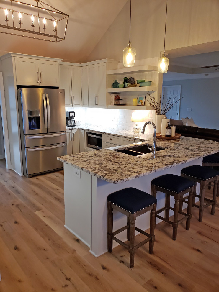 Example of a small trendy u-shaped vinyl floor and beige floor eat-in kitchen design in Nashville with a double-bowl sink, shaker cabinets, gray cabinets, granite countertops, white backsplash, porcelain backsplash, stainless steel appliances, a peninsula and multicolored countertops