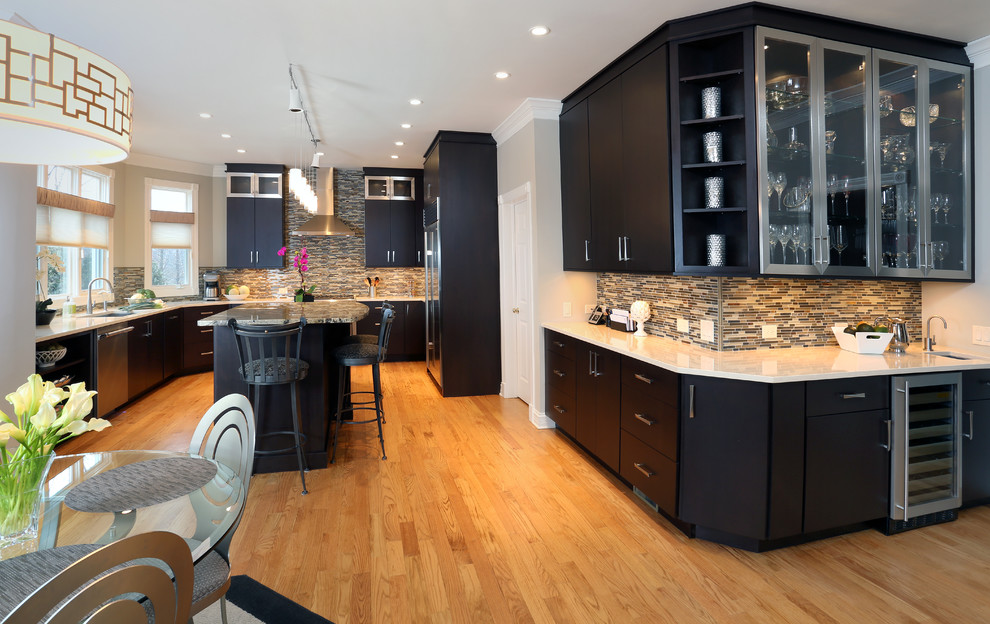 Kitchen - large contemporary u-shaped light wood floor kitchen idea in Chicago with an undermount sink, flat-panel cabinets, black cabinets, quartz countertops, gray backsplash, mosaic tile backsplash, stainless steel appliances and an island