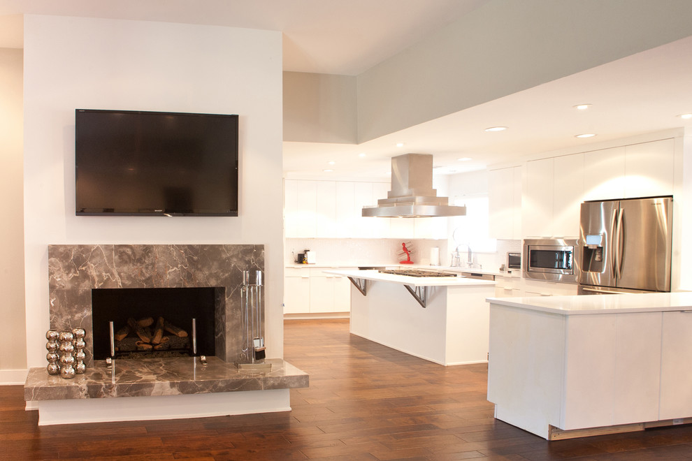 Example of a trendy u-shaped medium tone wood floor and brown floor eat-in kitchen design in Dallas with a single-bowl sink, flat-panel cabinets, white cabinets, quartz countertops, white backsplash, porcelain backsplash, stainless steel appliances and an island