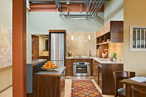 Inspiration for a mid-sized contemporary u-shaped light wood floor and beige floor eat-in kitchen remodel in Burlington with an undermount sink, medium tone wood cabinets, glass tile backsplash, stainless steel appliances, an island, flat-panel cabinets, solid surface countertops and beige backsplash