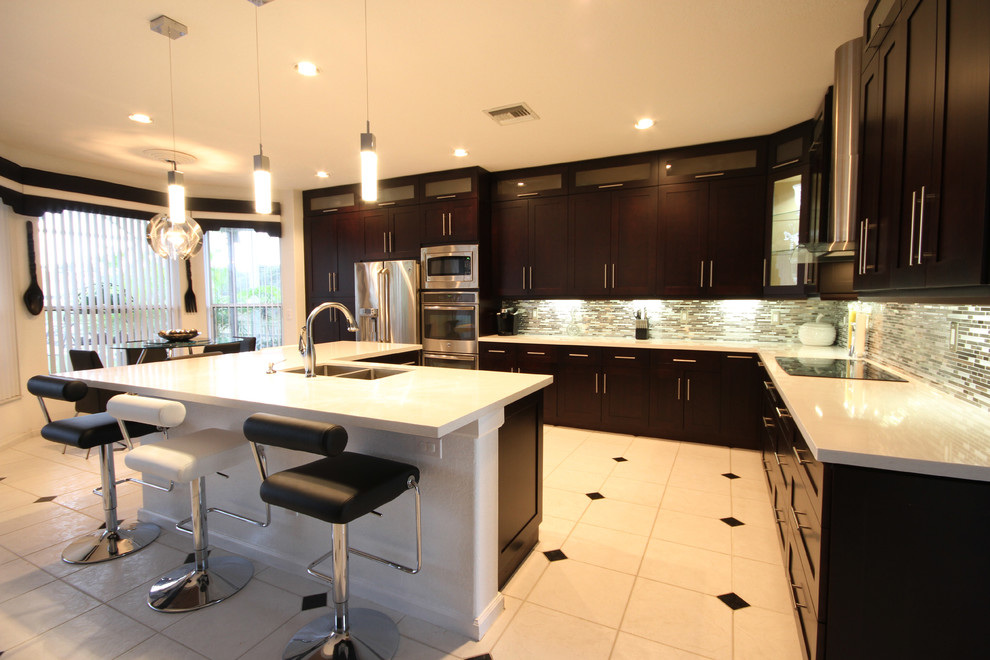 Eat-in kitchen - contemporary l-shaped eat-in kitchen idea in Miami with an undermount sink, shaker cabinets, brown cabinets, quartzite countertops, metallic backsplash and stainless steel appliances