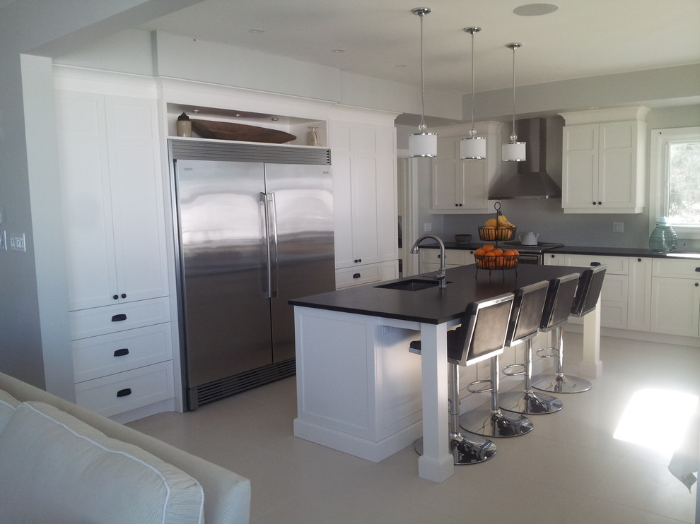 Contemporary white kitchen with quartz counter top Transitional