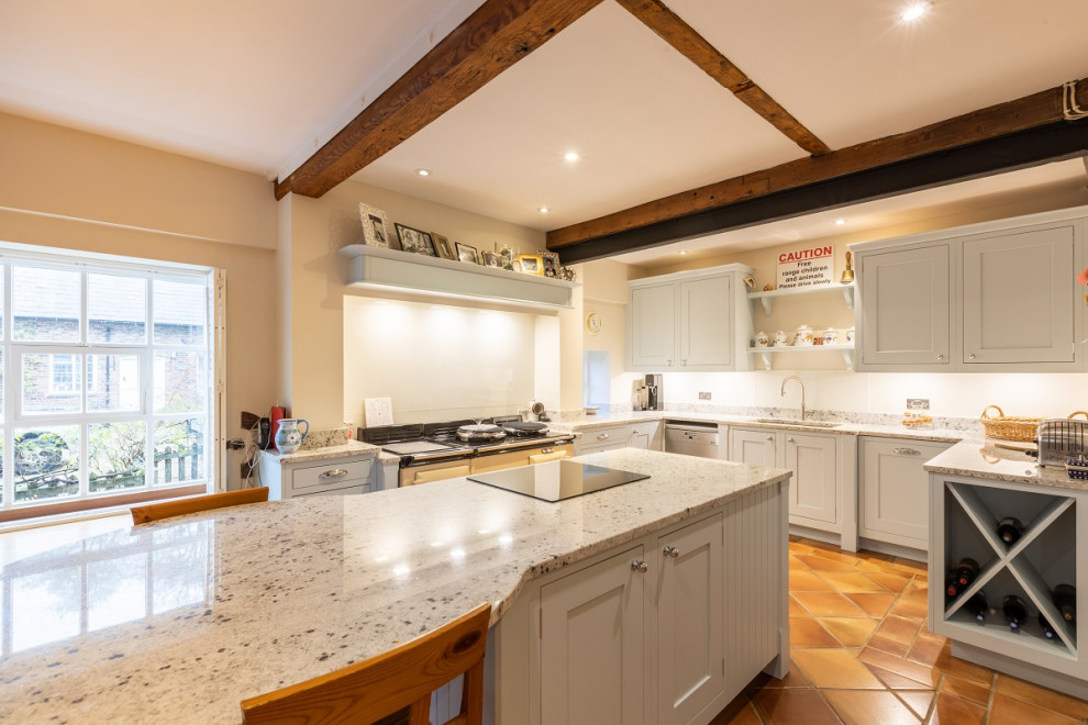 Inspiration for a large timeless eat-in kitchen remodel in Sussex with shaker cabinets, blue cabinets, granite countertops, white backsplash, glass sheet backsplash and an island