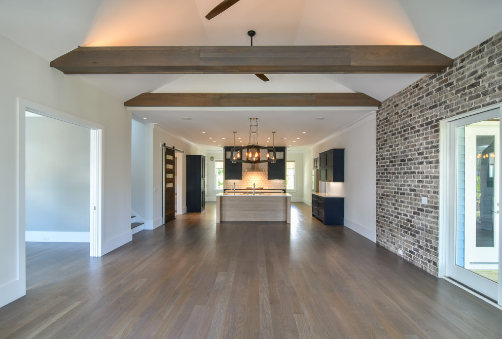 Inspiration for a mid-sized contemporary single-wall medium tone wood floor and brown floor open concept kitchen remodel in Charleston with a double-bowl sink, shaker cabinets, blue cabinets, quartz countertops, white backsplash, two islands and white countertops