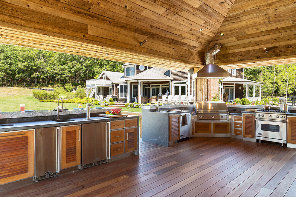 This is an example of a large rustic kitchen in New York with louvered cabinets, granite worktops and dark hardwood flooring.