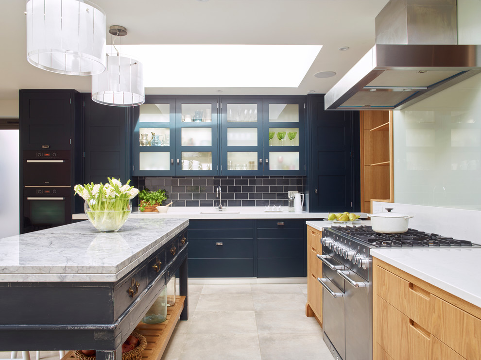 Inspiration for a large contemporary open plan kitchen in London with composite countertops, stainless steel appliances, porcelain flooring, an island, blue splashback and metro tiled splashback.