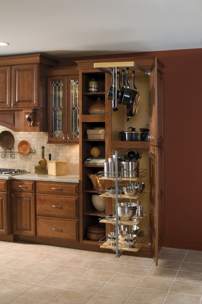 Elegant ceramic tile kitchen photo in Detroit with beige backsplash, ceramic backsplash, stainless steel appliances and medium tone wood cabinets