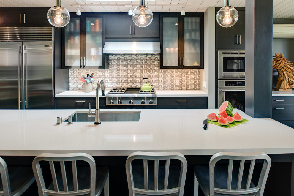 Eat-in kitchen - mid-sized contemporary galley cork floor eat-in kitchen idea in San Francisco with an undermount sink, flat-panel cabinets, dark wood cabinets, quartz countertops, gray backsplash, mosaic tile backsplash, stainless steel appliances and an island