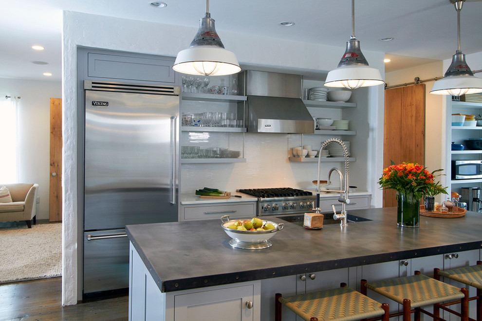 Example of a transitional eat-in kitchen design in Other with stainless steel appliances, flat-panel cabinets and gray cabinets