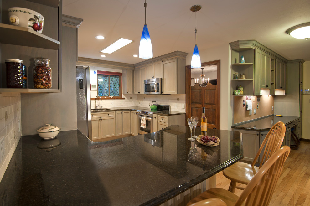 Mid-sized trendy u-shaped light wood floor eat-in kitchen photo in Boston with an undermount sink, shaker cabinets, gray cabinets, granite countertops, white backsplash, subway tile backsplash, stainless steel appliances and a peninsula