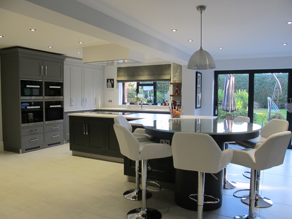 Foto på ett stort funkis kök och matrum, med luckor med infälld panel, grå skåp, träbänkskiva, klinkergolv i keramik och en halv köksö