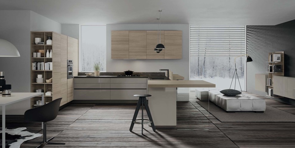 Mid-sized minimalist l-shaped porcelain tile open concept kitchen photo in New York with an undermount sink, flat-panel cabinets, beige cabinets, solid surface countertops, stainless steel appliances and a peninsula