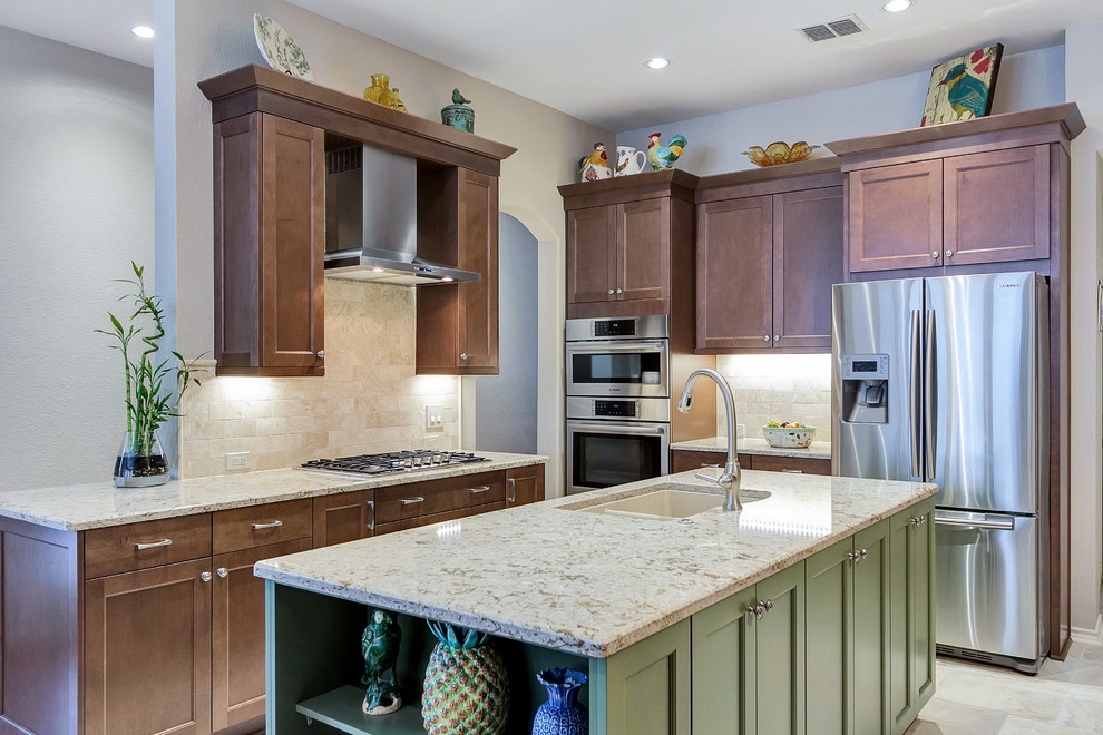 Inspiration for a mid-sized timeless l-shaped travertine floor eat-in kitchen remodel in Dallas with an undermount sink, recessed-panel cabinets, medium tone wood cabinets, quartz countertops, beige backsplash, stone tile backsplash, stainless steel appliances and an island