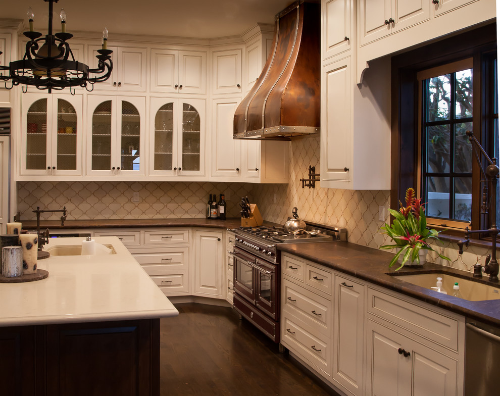 Exempel på ett avskilt, stort medelhavsstil l-kök, med luckor med profilerade fronter, vita skåp, granitbänkskiva, vitt stänkskydd, stänkskydd i keramik, färgglada vitvaror, mörkt trägolv, en köksö och en undermonterad diskho