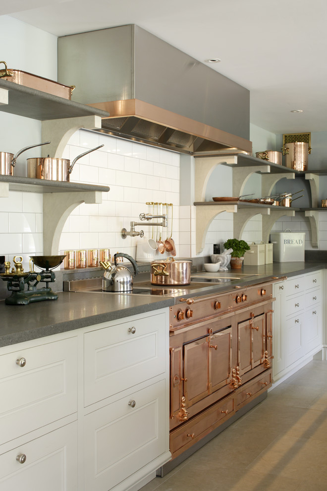 Inspiration for a large transitional l-shaped limestone floor enclosed kitchen remodel in Hampshire with a drop-in sink, recessed-panel cabinets, wood countertops, white backsplash, subway tile backsplash, colored appliances and an island