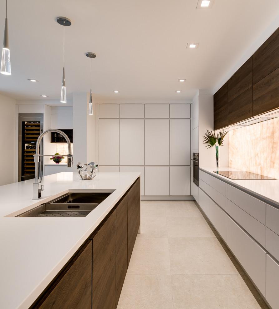 Large trendy galley porcelain tile and beige floor eat-in kitchen photo in Miami with an undermount sink, flat-panel cabinets, white cabinets, quartz countertops, white backsplash, stone slab backsplash, paneled appliances, an island and white countertops