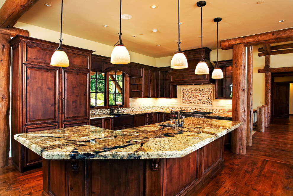 Kitchen - large rustic galley medium tone wood floor kitchen idea in Denver with a drop-in sink, raised-panel cabinets, medium tone wood cabinets, granite countertops, multicolored backsplash, mosaic tile backsplash and an island