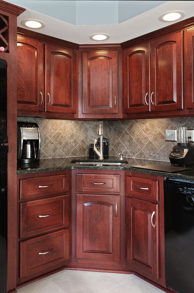 Mid-sized 1950s l-shaped ceramic tile eat-in kitchen photo in New York with a single-bowl sink, raised-panel cabinets, red cabinets, granite countertops, gray backsplash, ceramic backsplash and black appliances