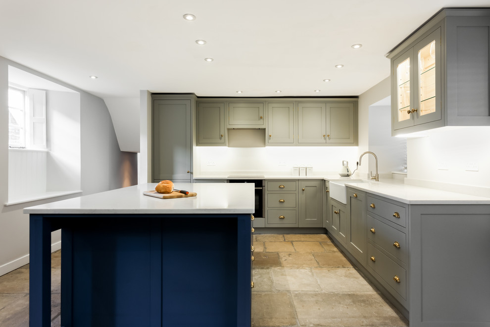 Traditional kitchen/diner in Dorset with shaker cabinets and an island.