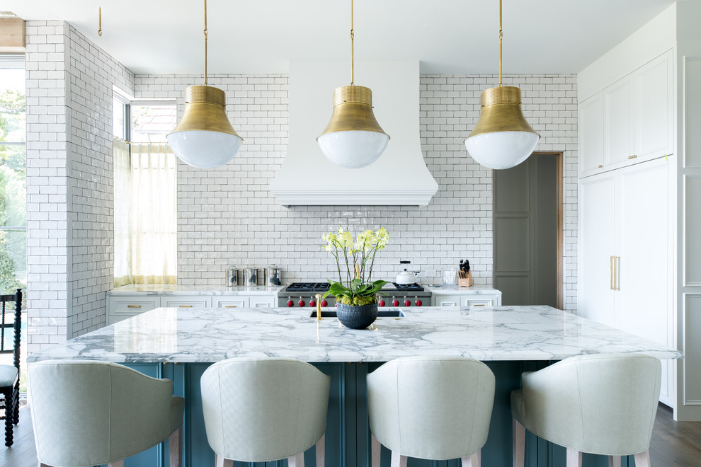 Inspiration for a medium sized contemporary u-shaped kitchen/diner in Dallas with a submerged sink, beaded cabinets, white cabinets, marble worktops, white splashback, metro tiled splashback, integrated appliances, medium hardwood flooring, an island and brown floors.