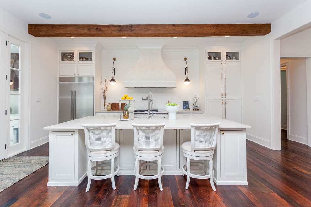 Photo of a farmhouse galley kitchen in New Orleans with a submerged sink, shaker cabinets, white cabinets, white splashback, stainless steel appliances and medium hardwood flooring.