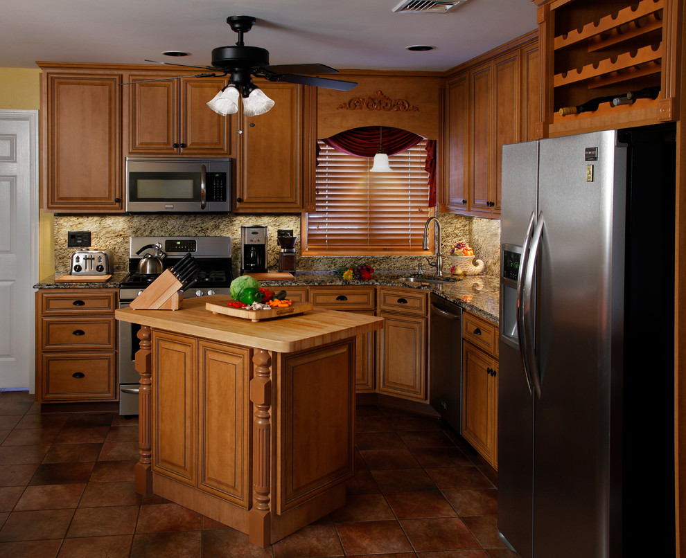 Idéer för att renovera ett mellanstort vintage kök, med en enkel diskho, luckor med upphöjd panel, skåp i mörkt trä, granitbänkskiva, brunt stänkskydd, stänkskydd i stenkakel, rostfria vitvaror, klinkergolv i porslin, en köksö och brunt golv