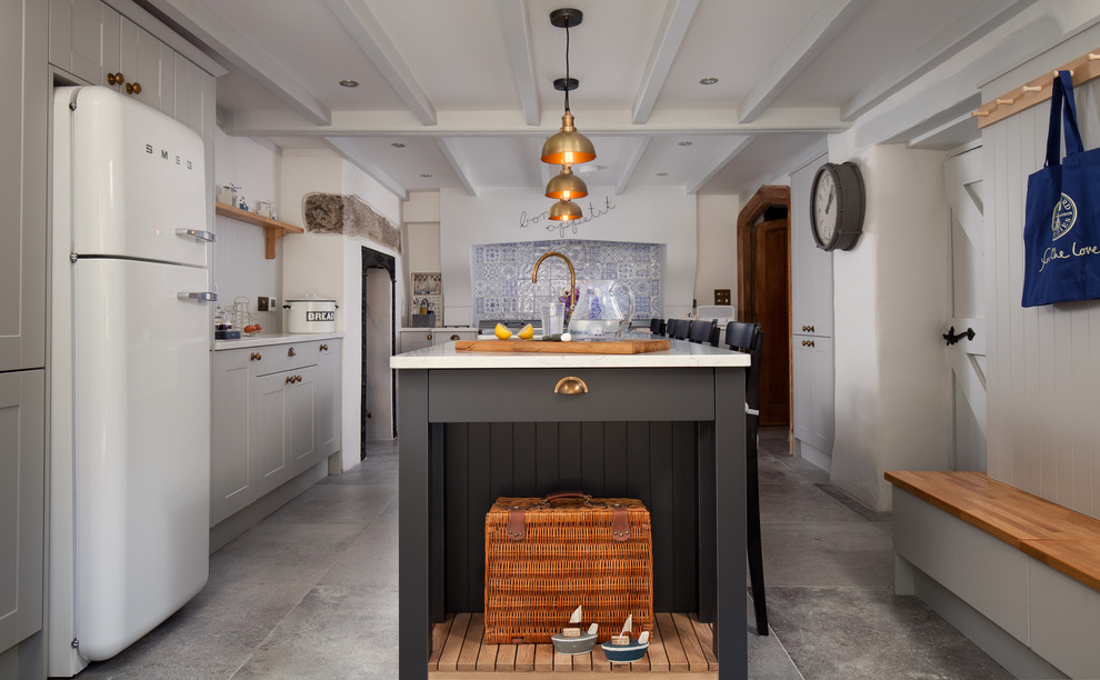 Inspiration for a medium sized country l-shaped enclosed kitchen in Cornwall with a belfast sink, recessed-panel cabinets, grey cabinets, quartz worktops, multi-coloured splashback, ceramic splashback, slate flooring, an island and grey floors.