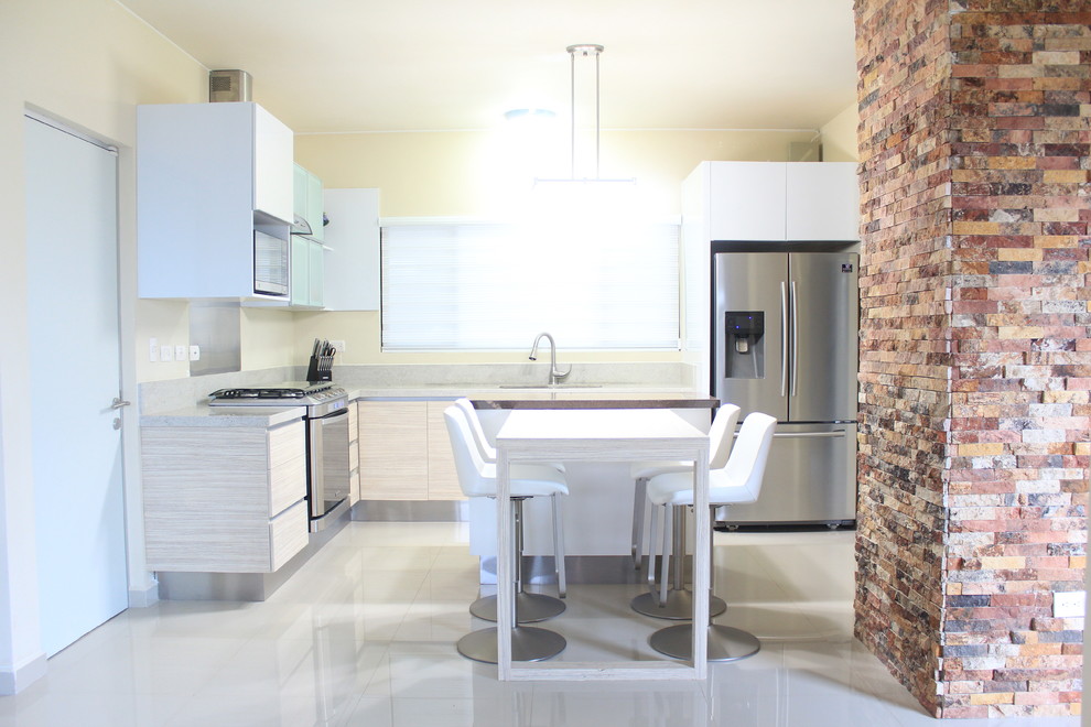 Photo of a medium sized modern l-shaped kitchen/diner in Other with a submerged sink, flat-panel cabinets, light wood cabinets, laminate countertops, multi-coloured splashback, stone slab splashback, stainless steel appliances, porcelain flooring and an island.