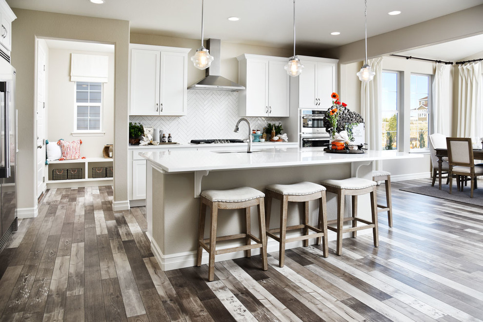Kitchen - contemporary multicolored floor kitchen idea in Denver with white cabinets, white backsplash, stainless steel appliances, an island and white countertops