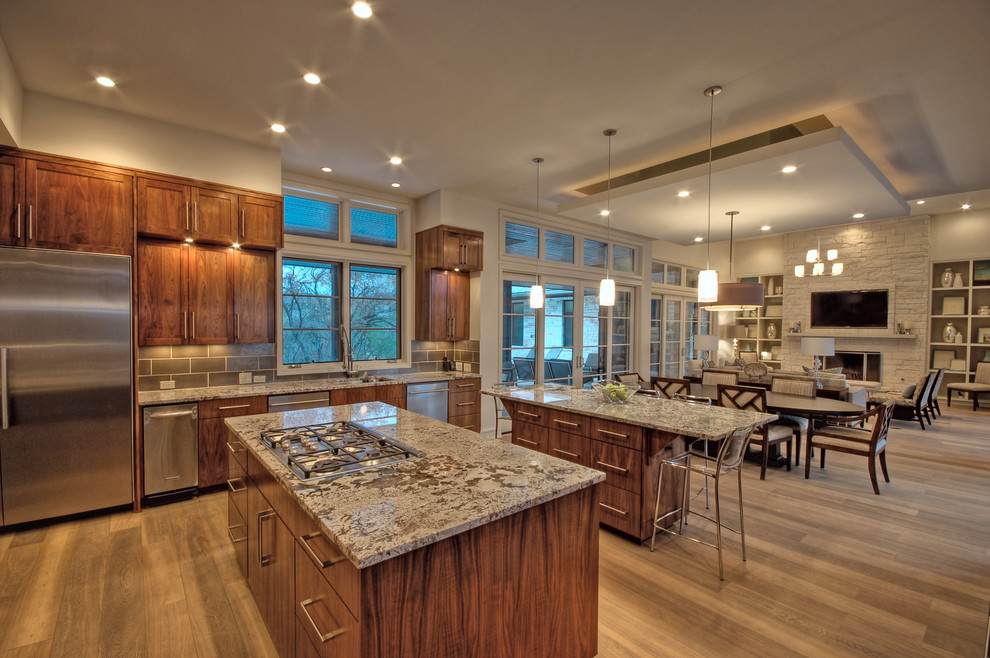 Open concept kitchen - transitional open concept kitchen idea in Austin with recessed-panel cabinets, dark wood cabinets and stainless steel appliances