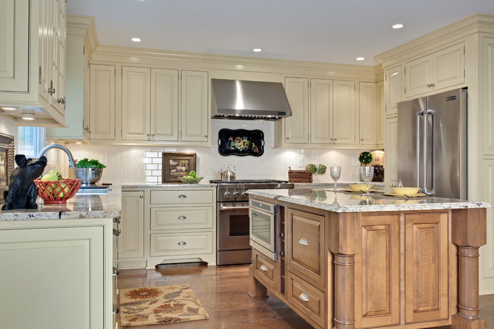 Example of a huge classic u-shaped medium tone wood floor and brown floor eat-in kitchen design in Atlanta with an undermount sink, beaded inset cabinets, light wood cabinets, granite countertops, white backsplash, subway tile backsplash, stainless steel appliances, an island and white countertops