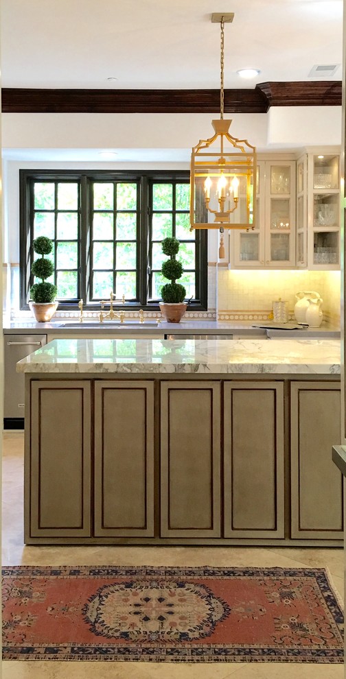 Example of a mid-sized tuscan u-shaped travertine floor and beige floor eat-in kitchen design in Orange County with an undermount sink, shaker cabinets, green cabinets, marble countertops, beige backsplash, terra-cotta backsplash, stainless steel appliances, an island and beige countertops