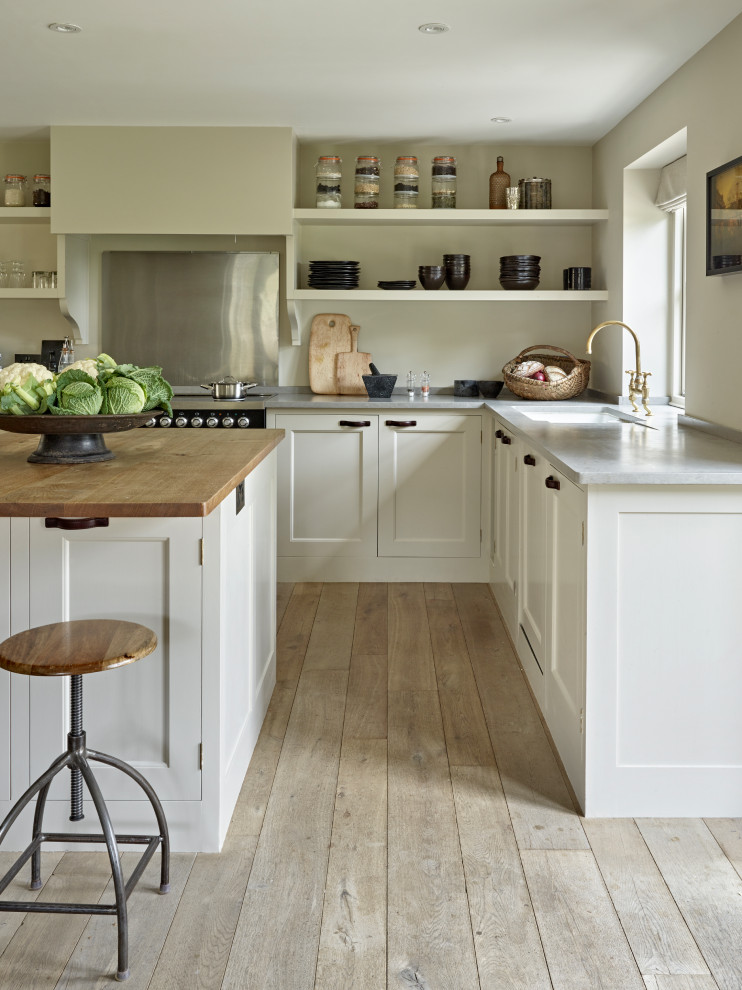 Inspiration for a large classic l-shaped kitchen in Gloucestershire with a submerged sink, shaker cabinets, white cabinets, an island, beige floors and grey worktops.