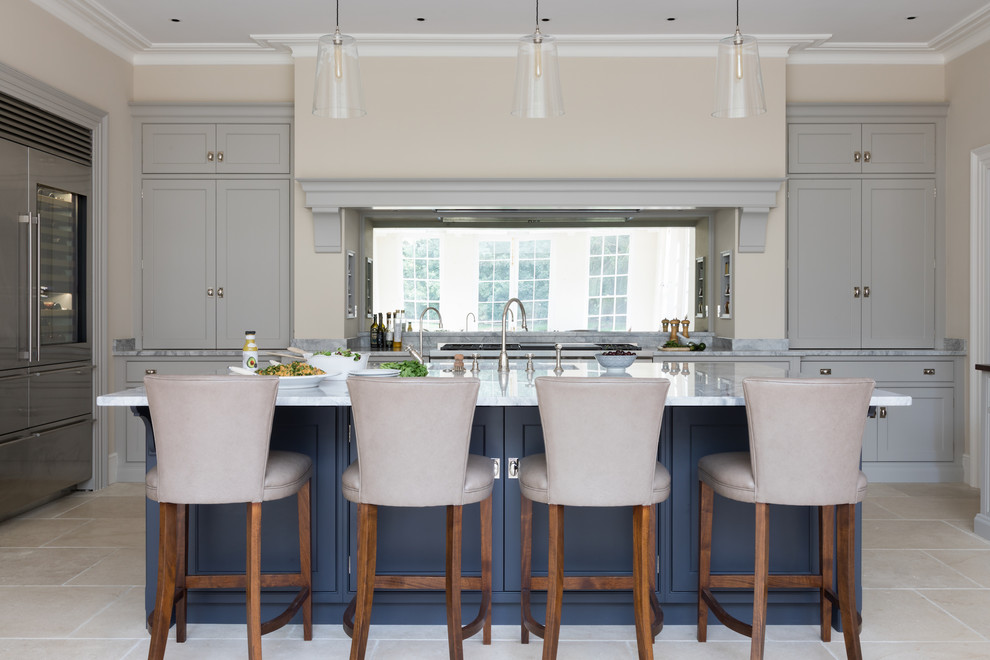 Example of a large transitional beige floor kitchen design in Oxfordshire with shaker cabinets, gray cabinets, mirror backsplash, stainless steel appliances, an island and gray countertops