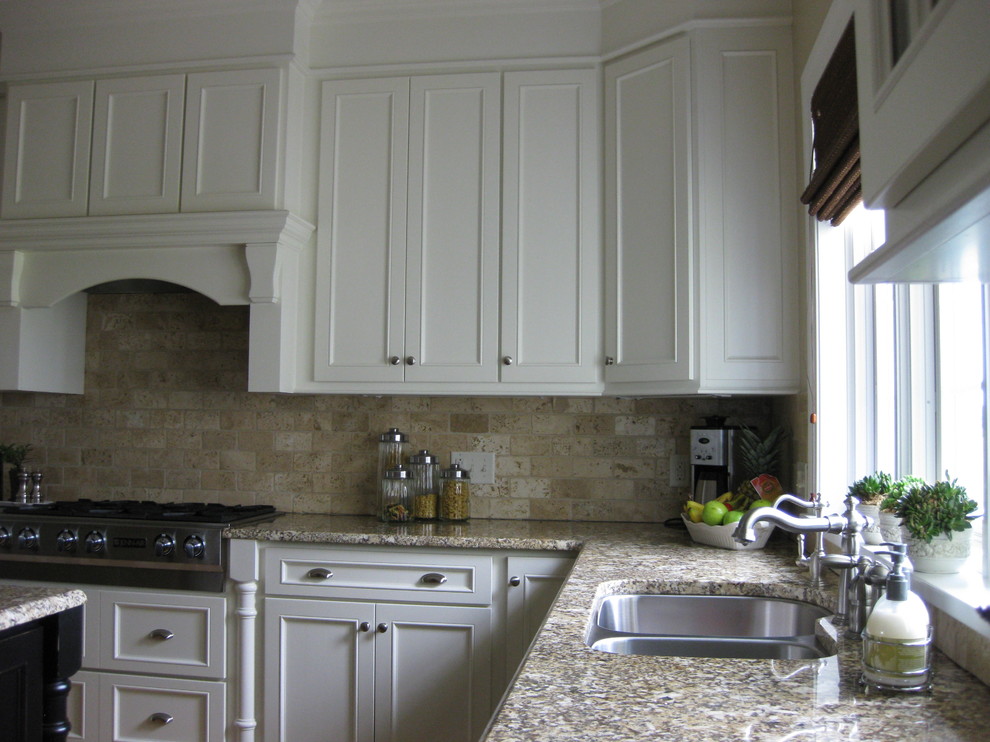 Medium sized classic single-wall enclosed kitchen in Minneapolis with a double-bowl sink, shaker cabinets, white cabinets, granite worktops, beige splashback, porcelain splashback, stainless steel appliances, medium hardwood flooring and an island.