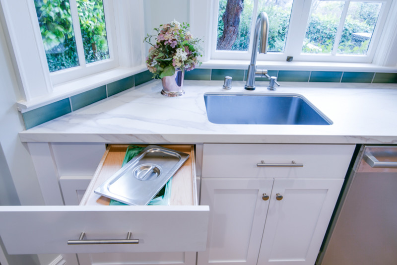 Inspiration for a craftsman kitchen remodel in San Francisco with a single-bowl sink, raised-panel cabinets, blue cabinets, blue backsplash, subway tile backsplash, stainless steel appliances, an island and white countertops