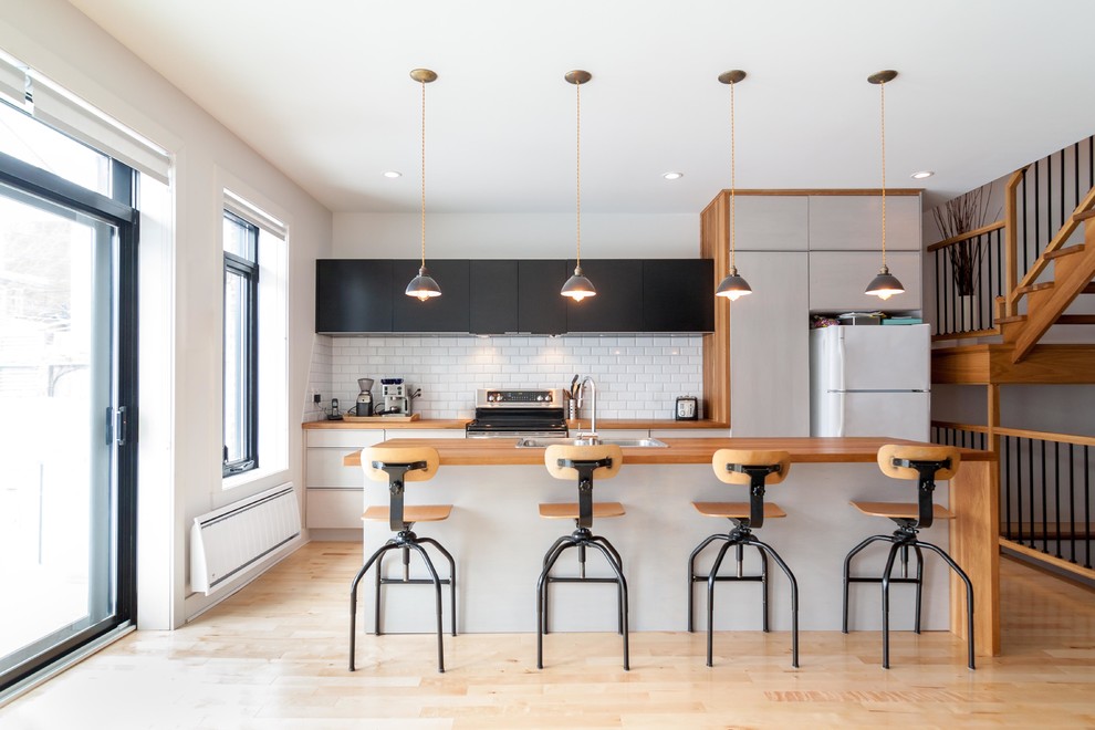 Contemporary kitchen in Montreal with wood worktops.