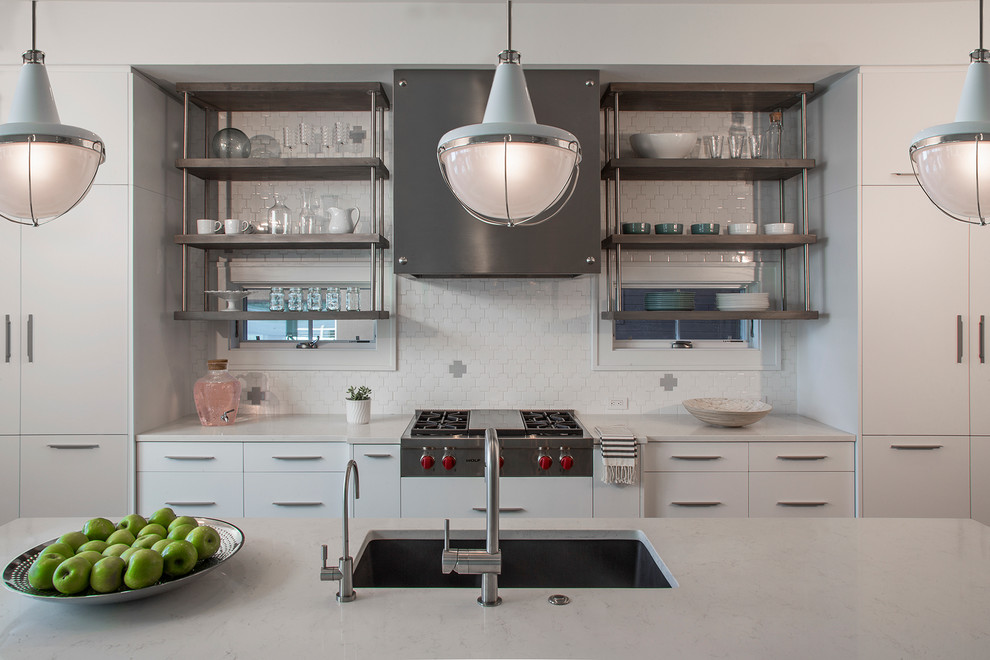 Inspiration for a contemporary kitchen remodel in Detroit with an undermount sink, open cabinets, stainless steel cabinets, white backsplash, stainless steel appliances and an island