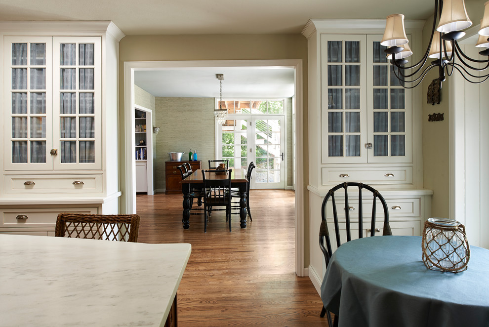 This is an example of a large classic l-shaped kitchen/diner in Denver with a submerged sink, recessed-panel cabinets, white cabinets, marble worktops, white splashback, brick splashback, stainless steel appliances, dark hardwood flooring and an island.