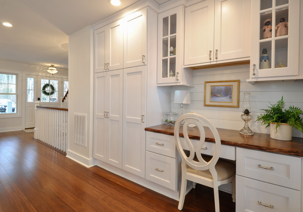 Example of a large beach style u-shaped dark wood floor eat-in kitchen design in DC Metro with an undermount sink, recessed-panel cabinets, white cabinets, stainless steel appliances and an island