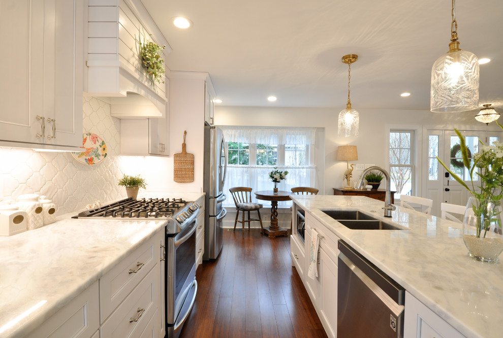 Eat-in kitchen - large coastal u-shaped dark wood floor eat-in kitchen idea in DC Metro with an undermount sink, recessed-panel cabinets, white cabinets, stainless steel appliances and an island