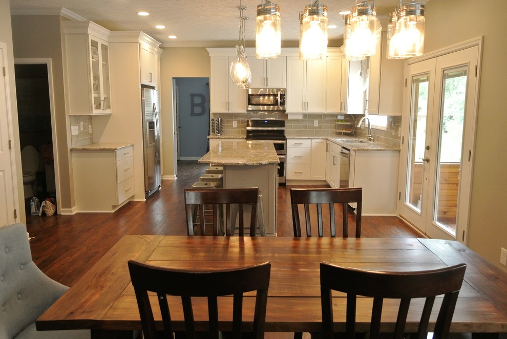 Large transitional u-shaped dark wood floor eat-in kitchen photo in Indianapolis with an undermount sink, raised-panel cabinets, white cabinets, granite countertops, gray backsplash, ceramic backsplash, stainless steel appliances and an island